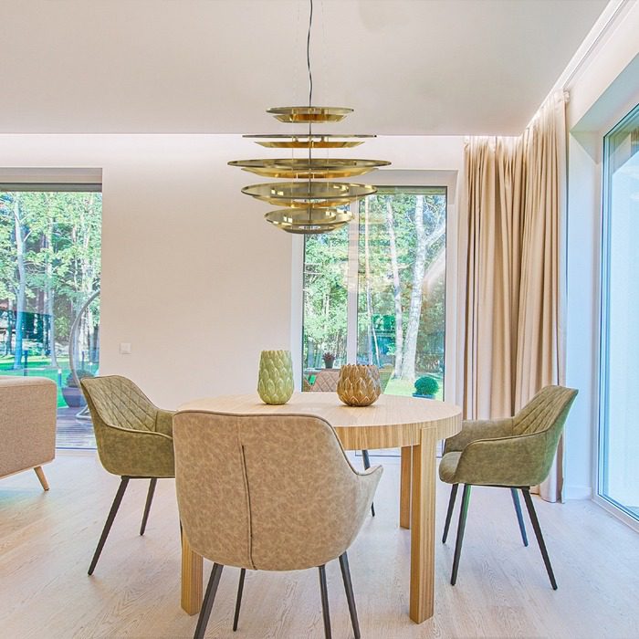 beige dining room with golden chandelier